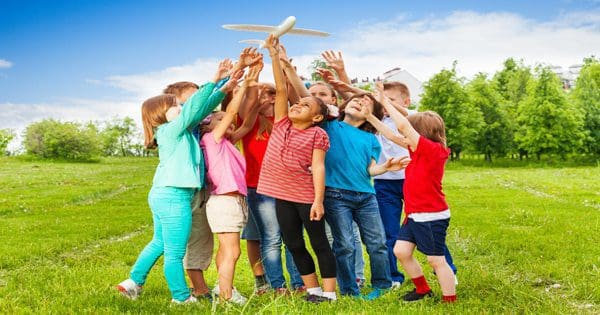 blog picture of children playing with toy plane