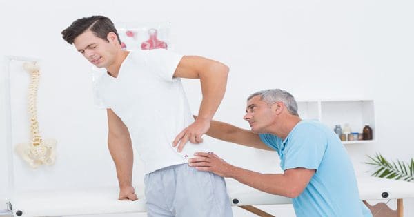 blog picture of man getting back checked by chiropractor