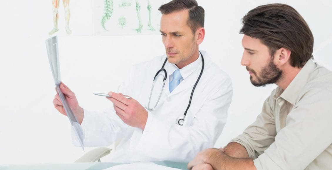 chiropractor talks with patient