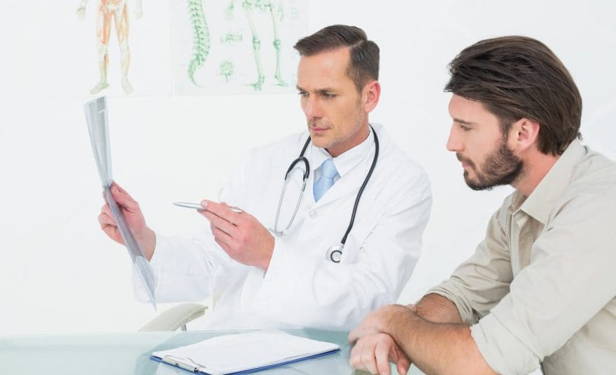 chiropractor talks with patient